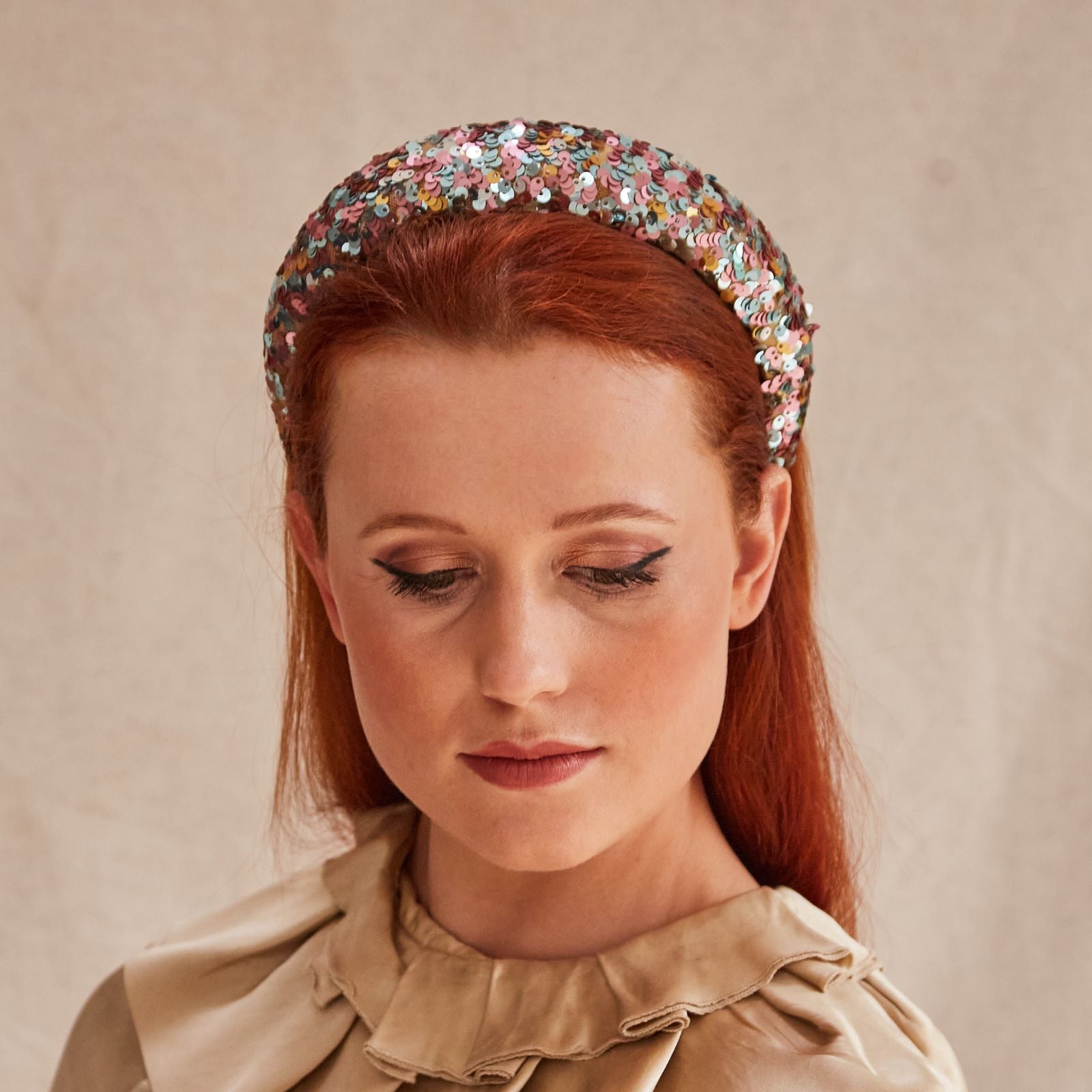 Multicolour pink sequin headband, front view.