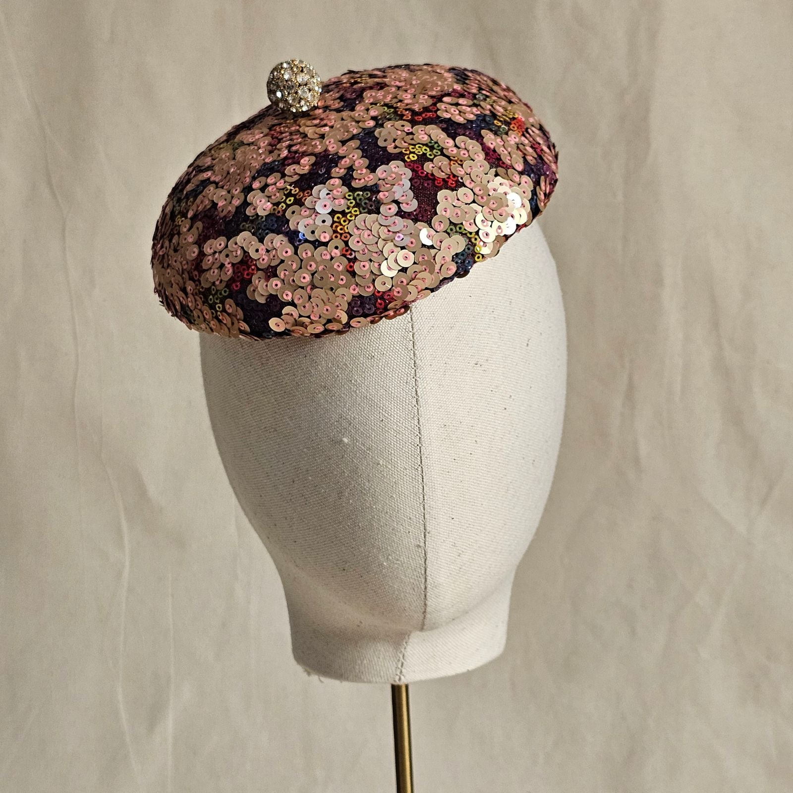 Multicolour sequin beret with crystal diamanté globe embellishment, front view.