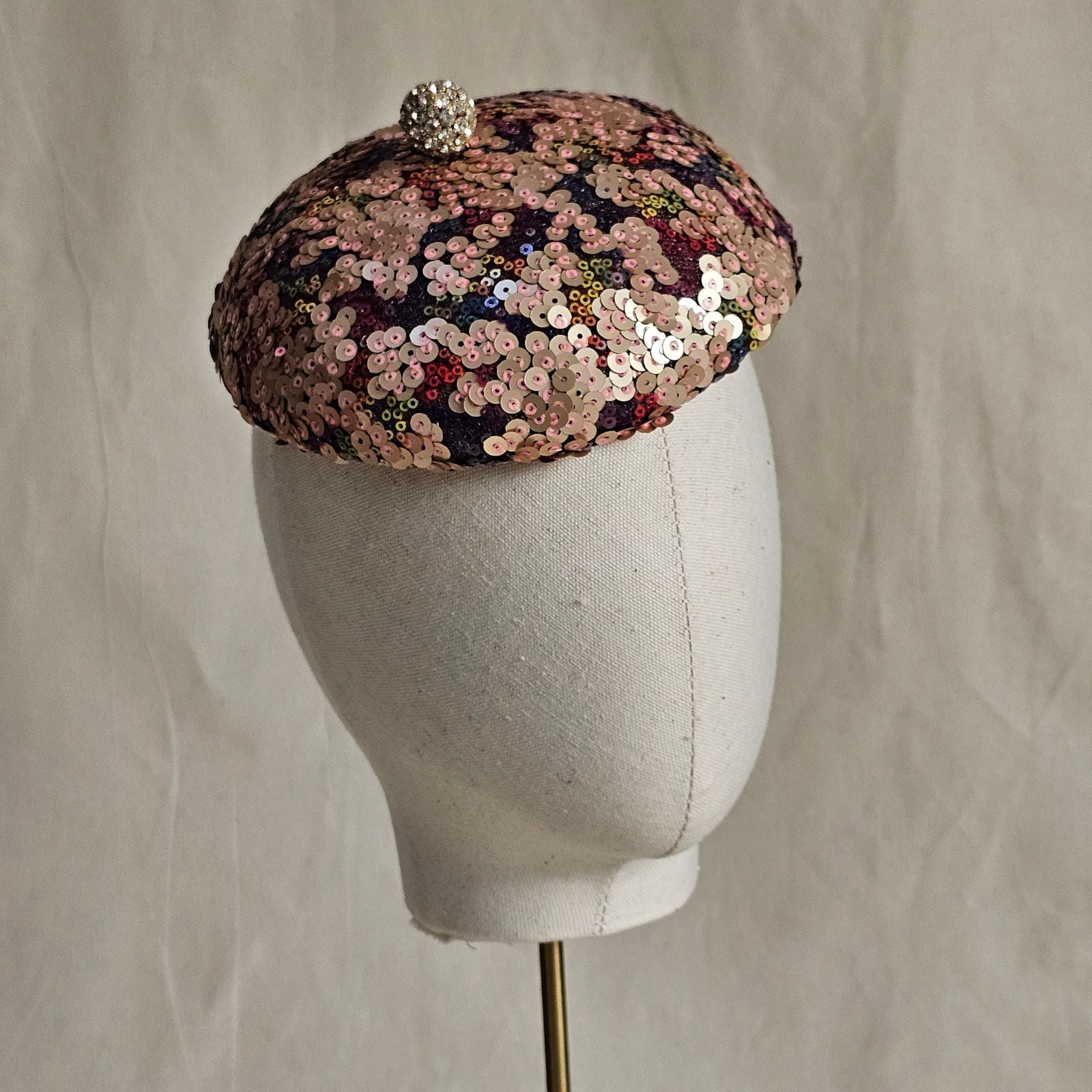 Multicolour sequin beret with crystal diamanté globe embellishment, side view.