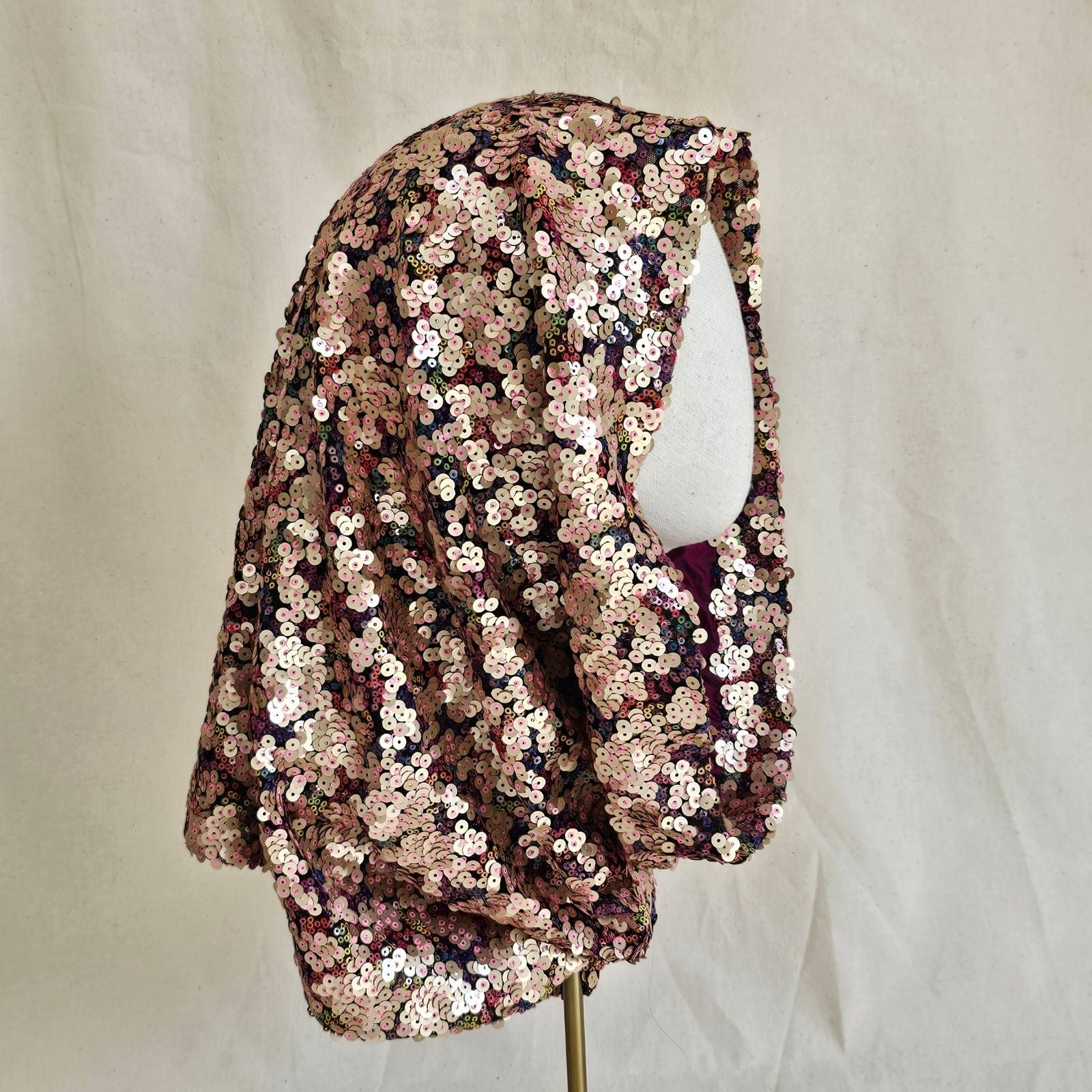 Softly sculpted multicolour designer sequin snood, side view.
