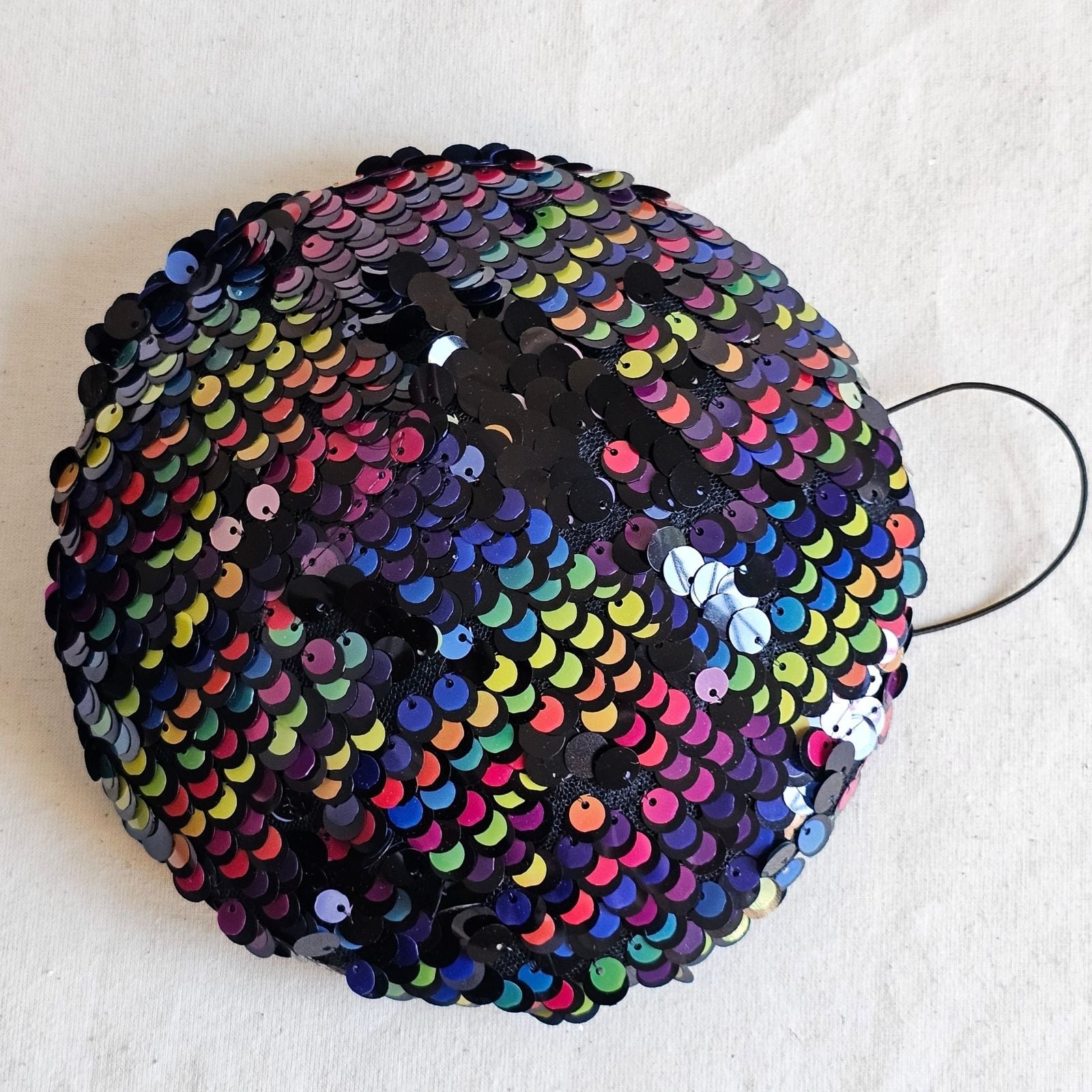 Multicoloured sequin beret, top view.