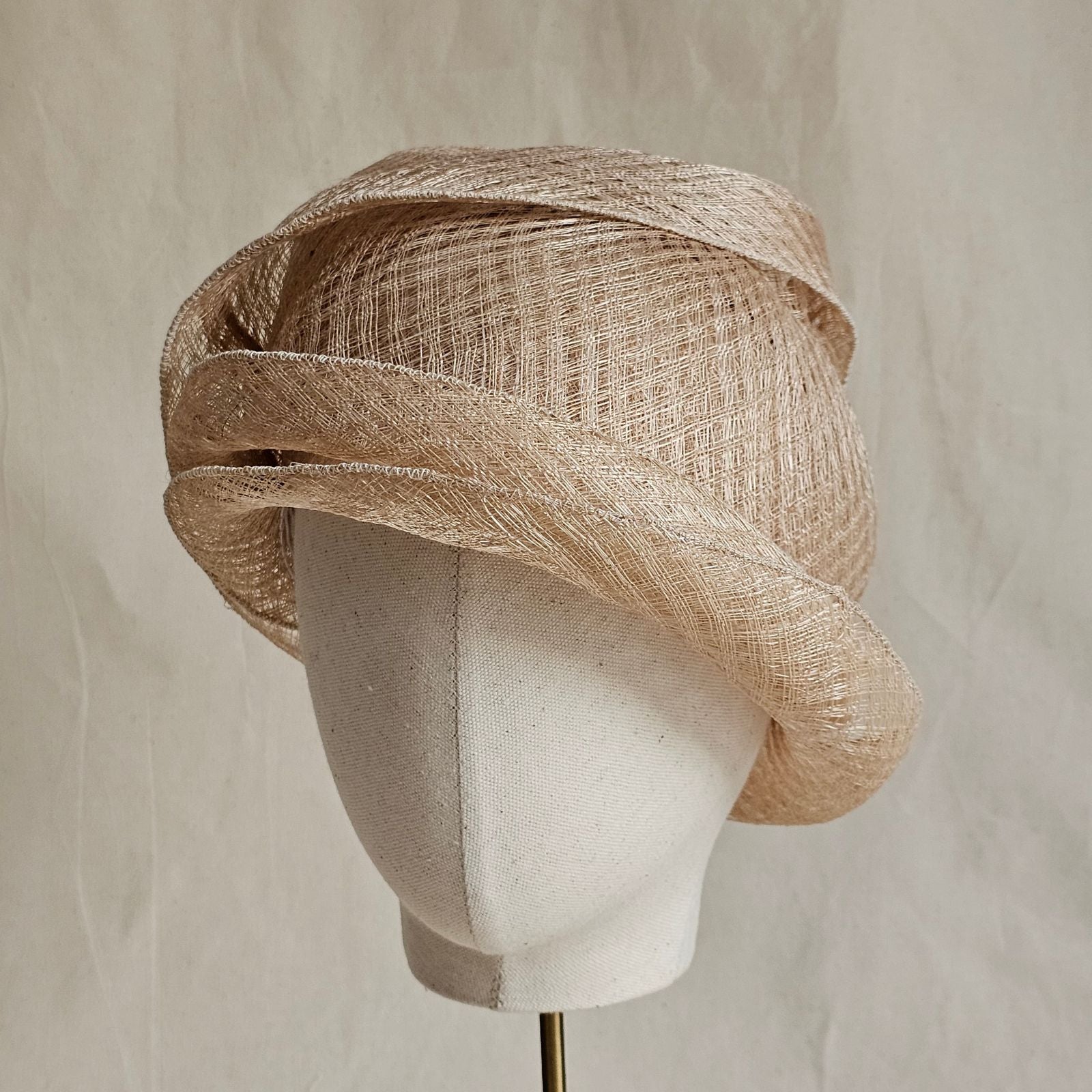 Natural mesh siname cloche hat, angle view.