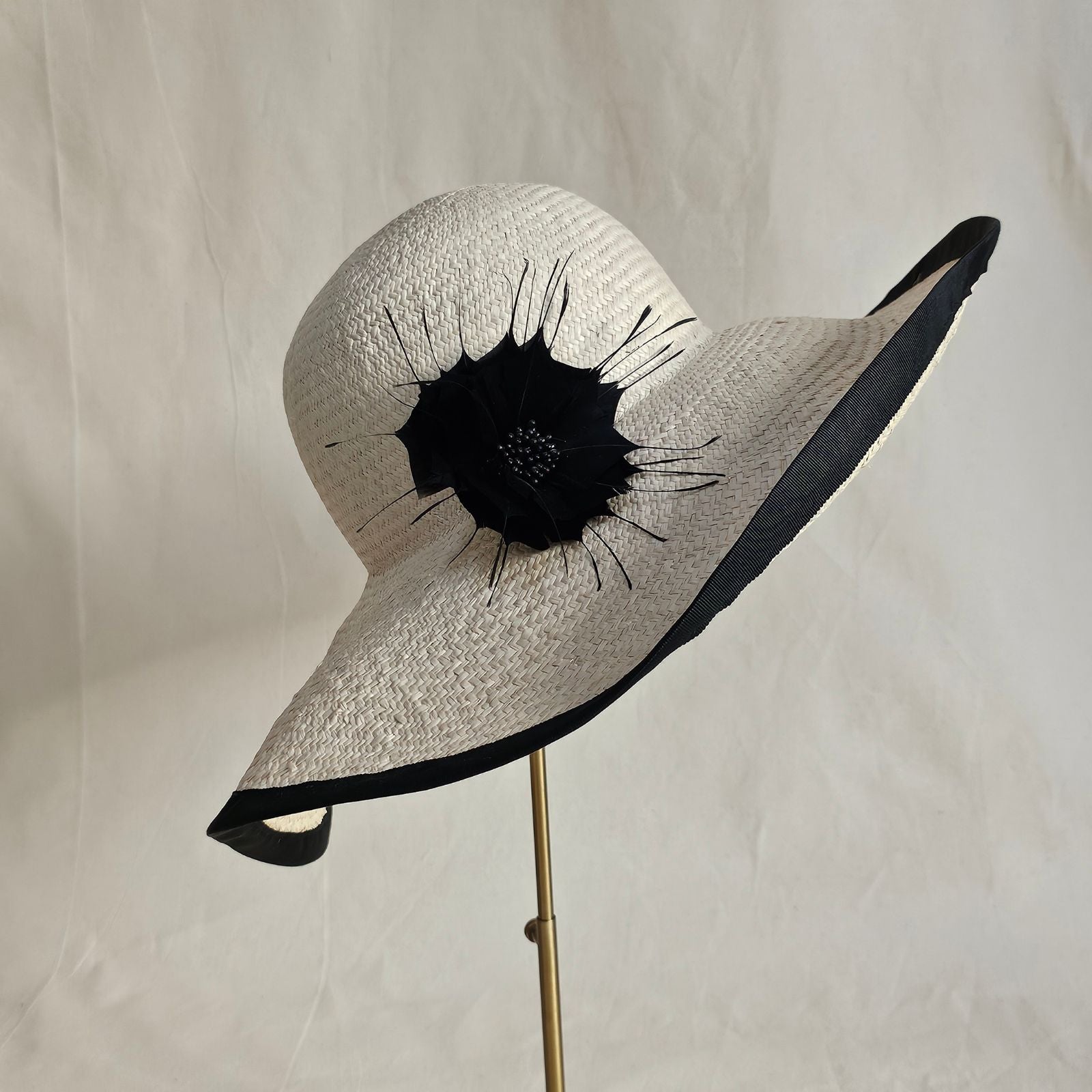 natural straw sunhat with beautiful black flower and rim, right view.