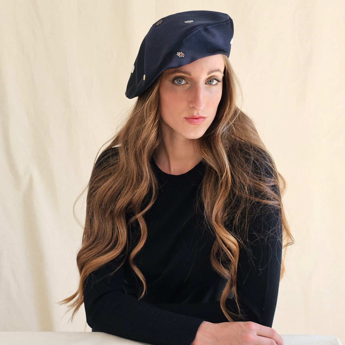 Navy silk duchesse satin tam o'shanter with small monograms,
worn on a model.