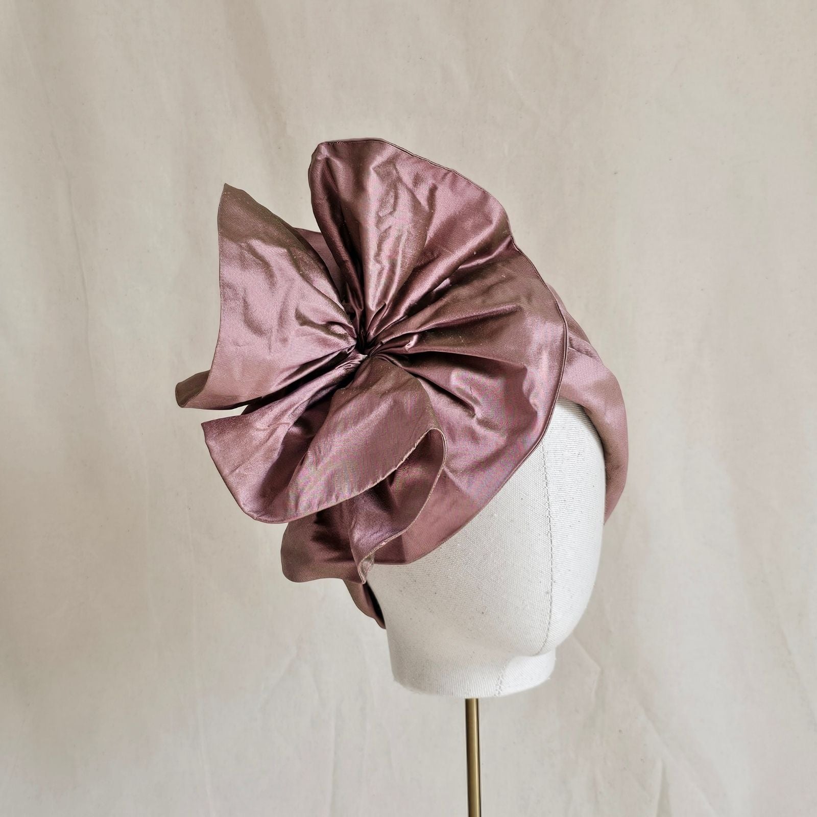 Pink silk turban with elegant ruffle, angle view.
