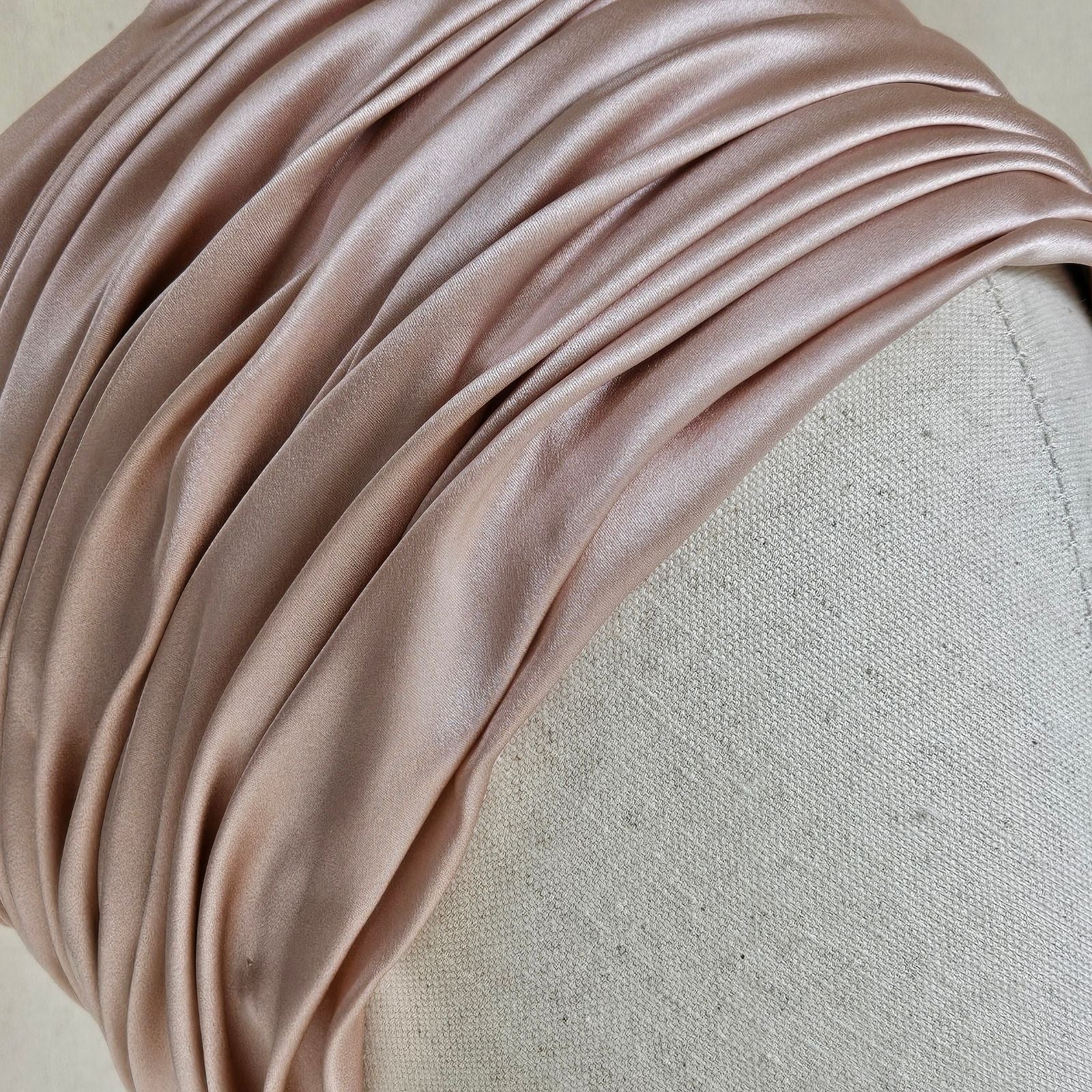 Detail of softly gathered pink silk satin turban.