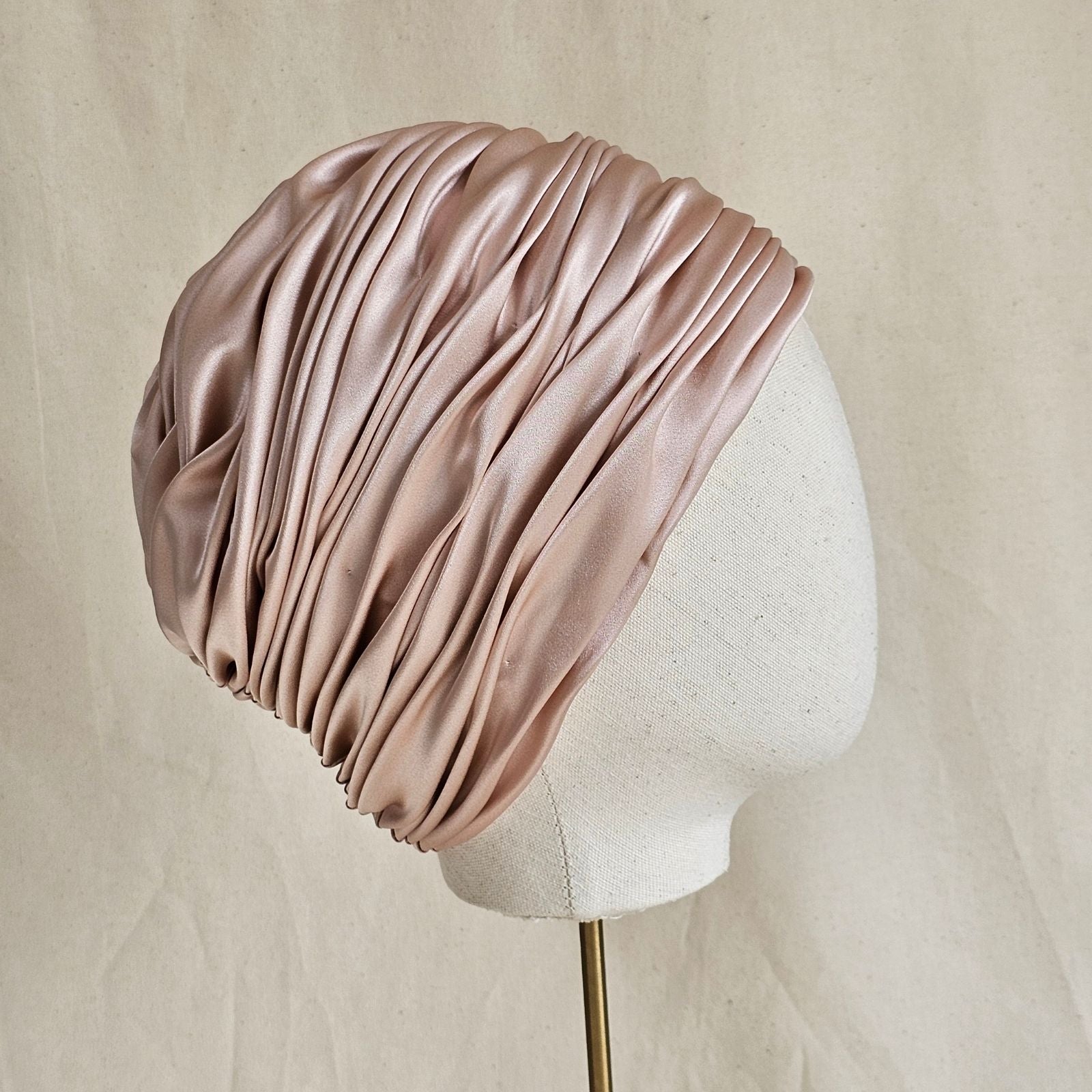 Pink silk and satin luxury gathered turban, side view.