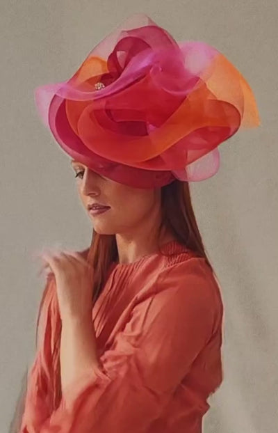 Nerida Fraiman model dancing wearing a luxury fascinator, London milliner