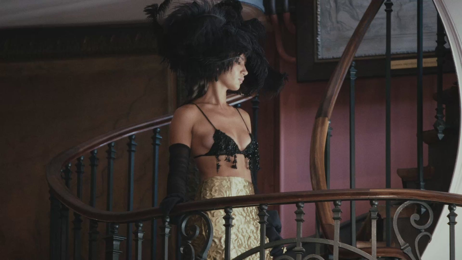 Model wearing an oversized black feather hat by Nerida Fraiman at the Azzopardi fashion show.