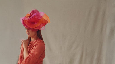Nerida Fraiman model dancing wearing a luxury fascinator, London milliner