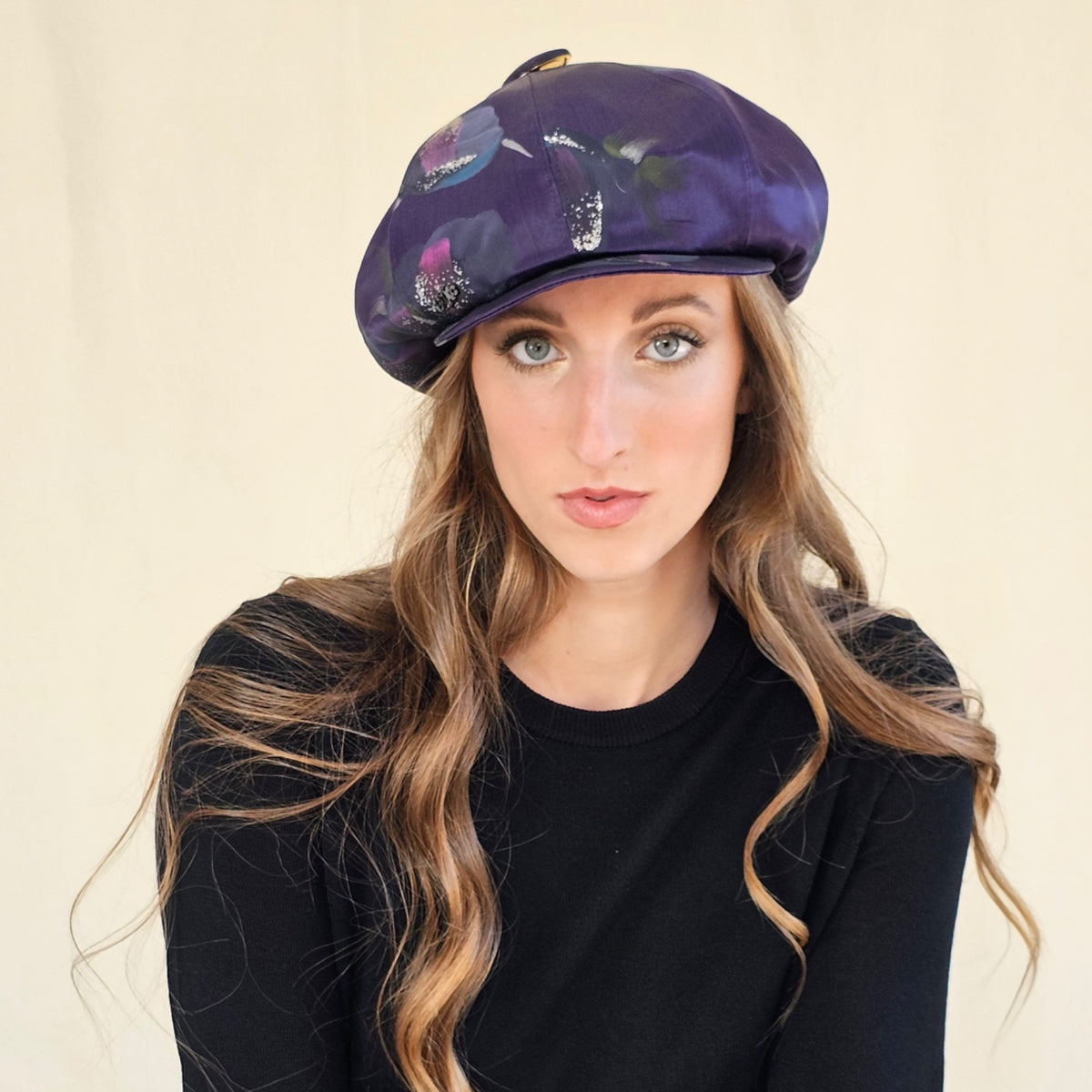 Front close-up of purple silk baker boy cap showing hand-painted
pattern