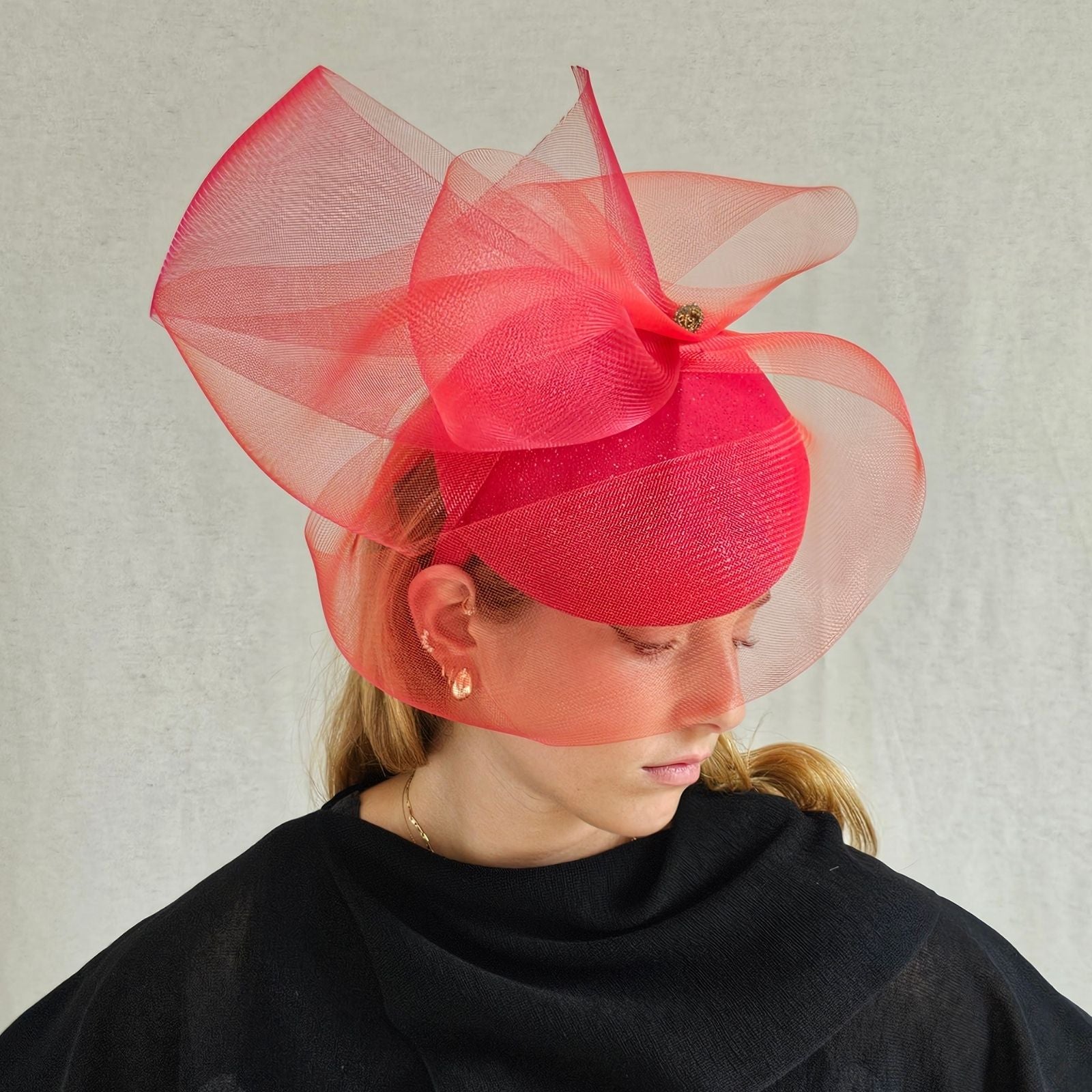 Red sparkle beret with elegant crin swirl veil, angle view.