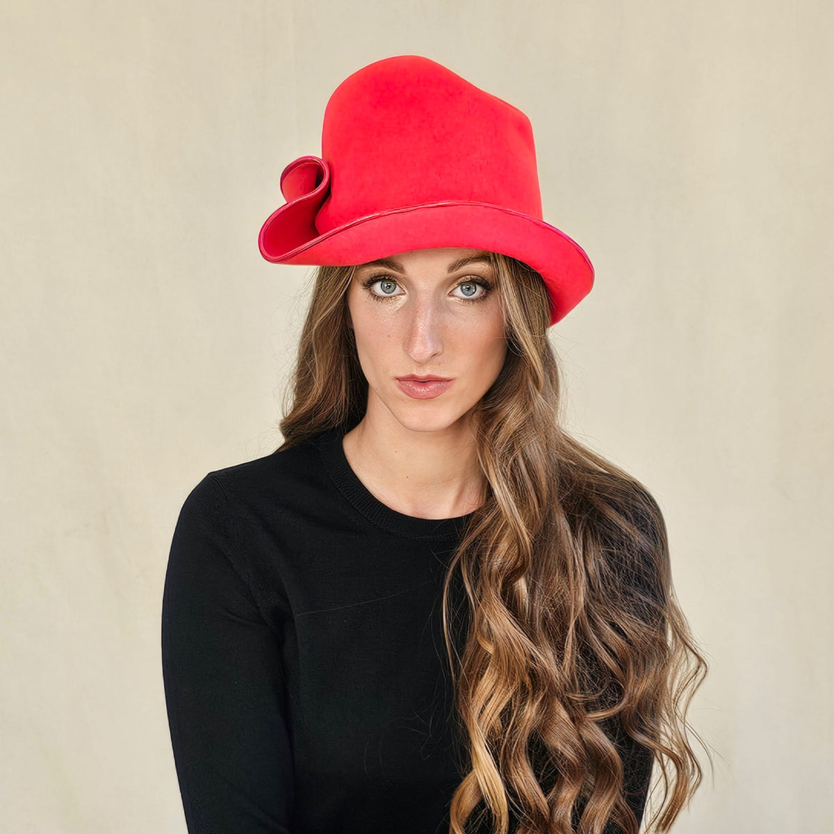 Front view of red felt cloche on a seated model.