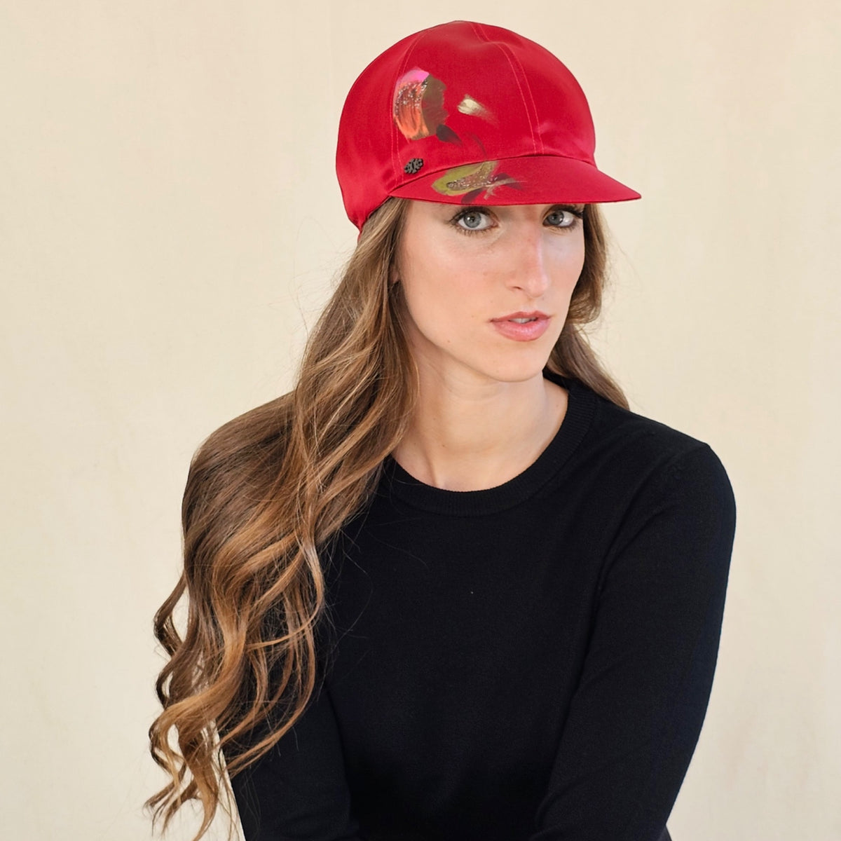 Angled view of red hand-painted silk baseball cap.