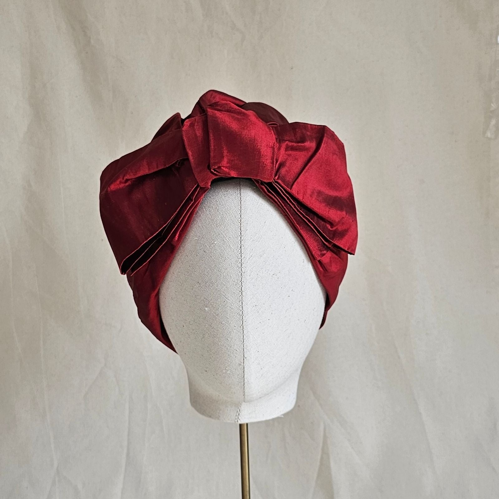 Red silk turban with beautiful bow, front view.