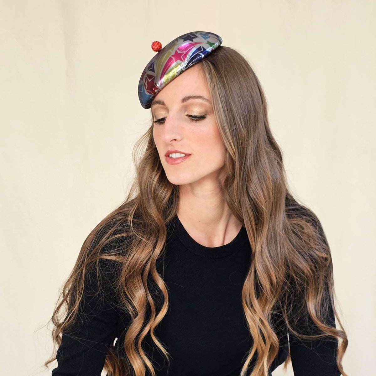 Side view of silver star-patterned beret showing its raised red
globe.