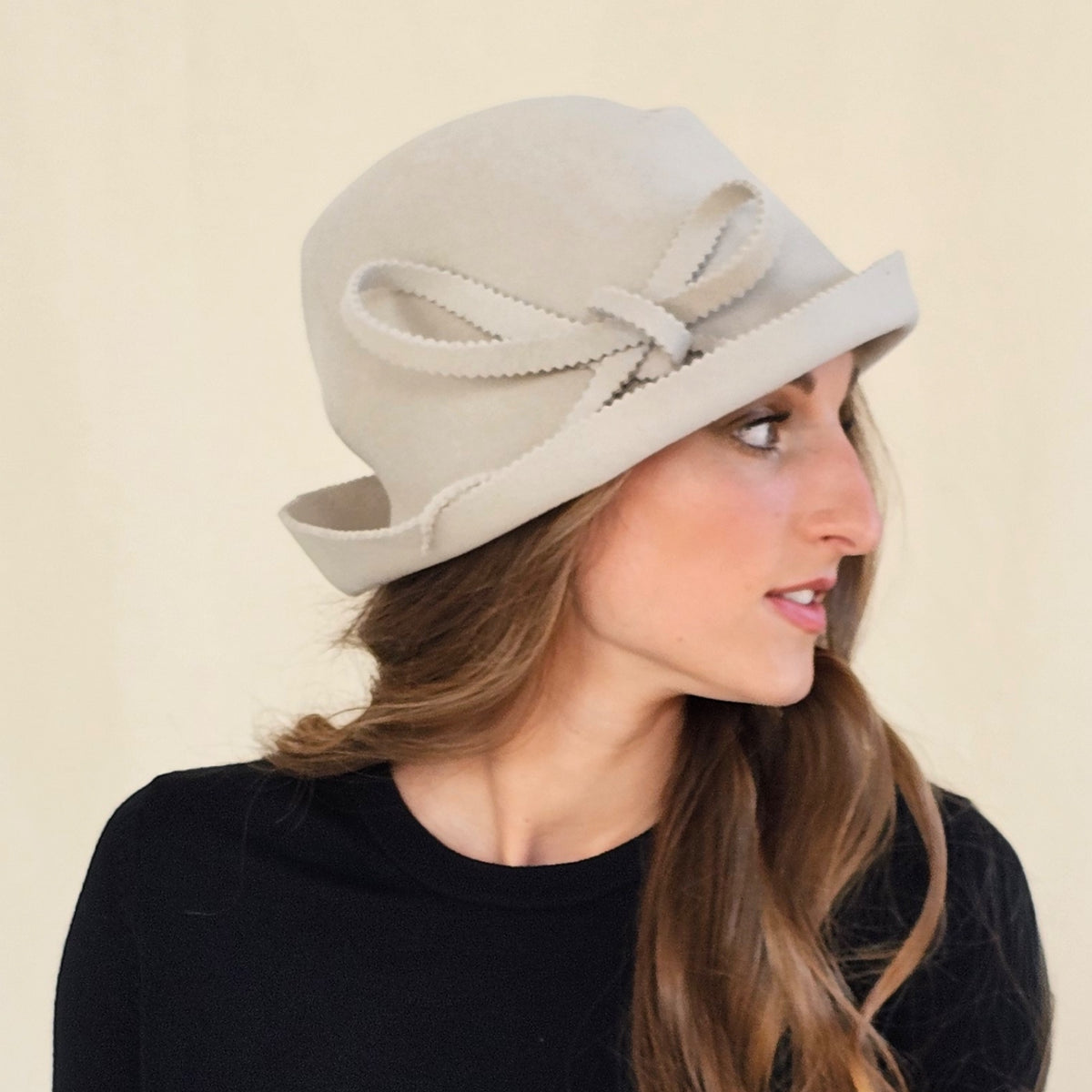 Side view of stone felt trilby showing layered loop bow and zigzag cut
edges.