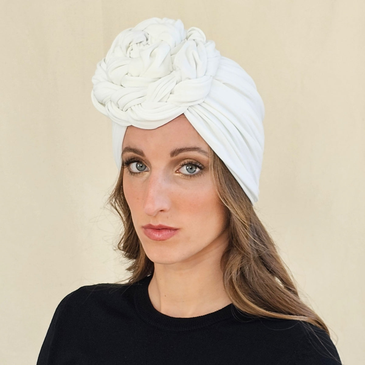 Close-up of white jersey turban showing the coiled braid rose and
gathered folds.